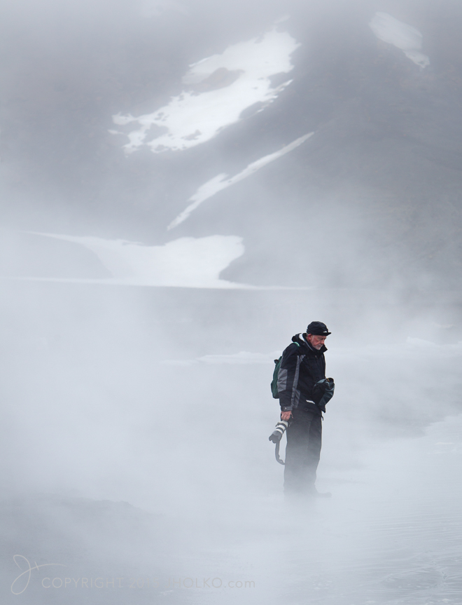 Photographer pauses to admire the beauty, partially hidden by ri